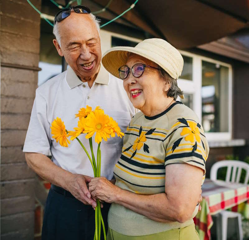 Older Couple Walking Flowers
