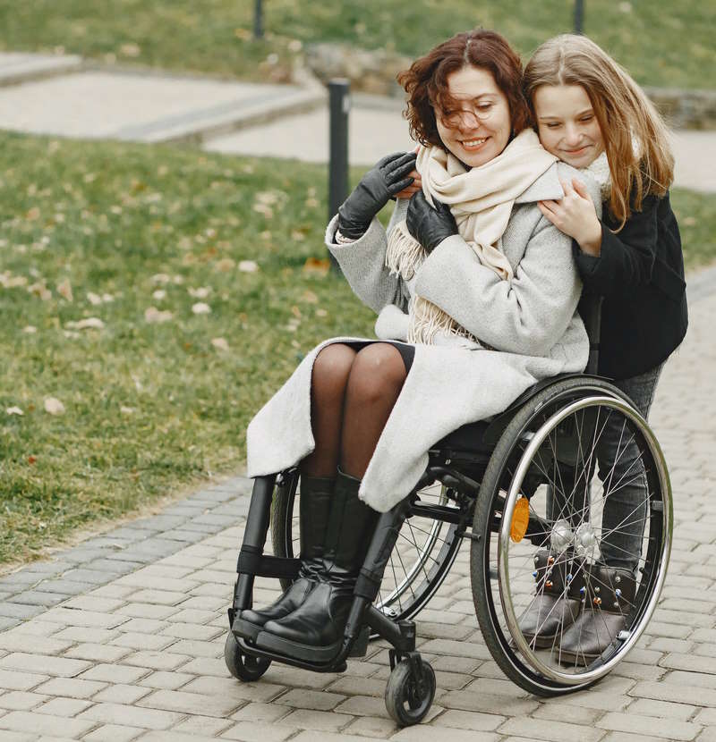 Woman in wheelchair hugs daughter