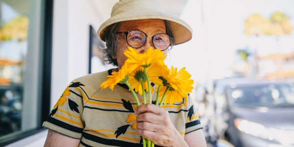 Senior Woman Smelling Flowers