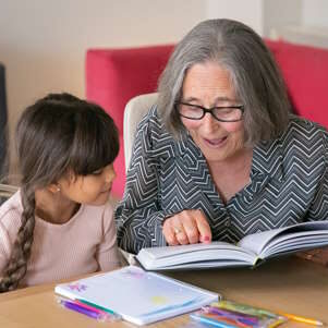 Senior Woman Reading with Child